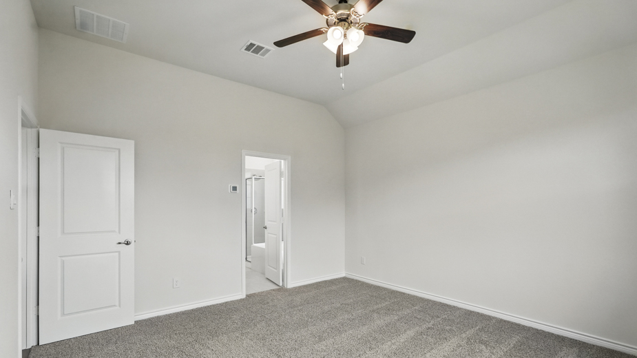 Primary bedroom with carpeted floors and a closet.