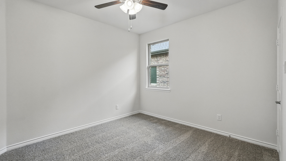 Bedroom with a single window and carpeted floors.