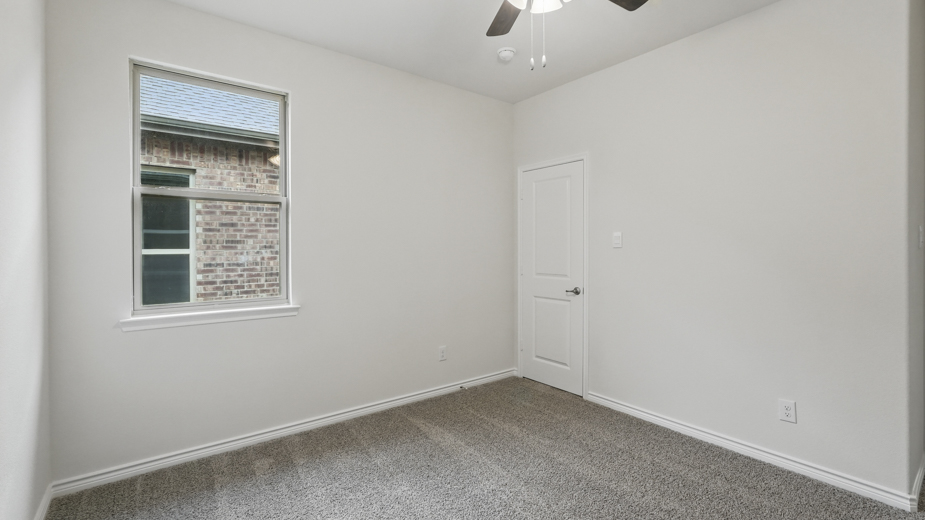 Bedroom with a single window and carpeted floors.
