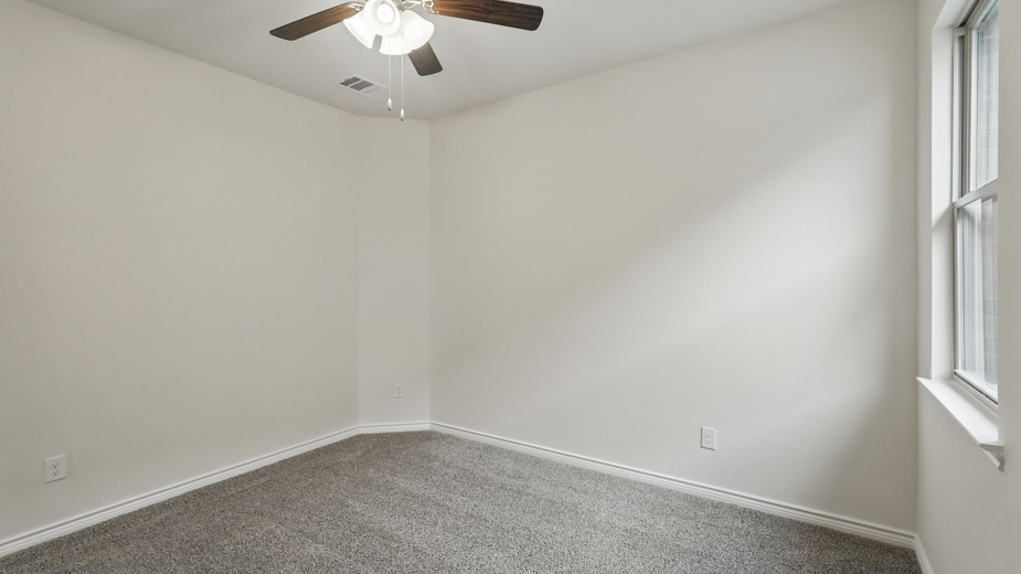 Bedroom with a single window and carpeted floors.