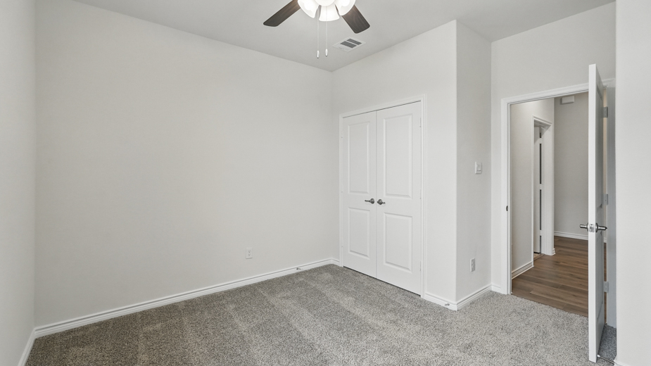 Bedroom with carpeted floors and a closet.
