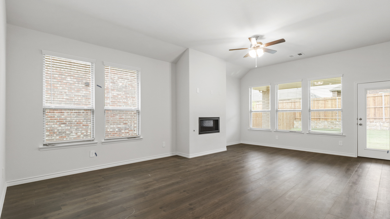 large living room with fireplaces and lots of windows
