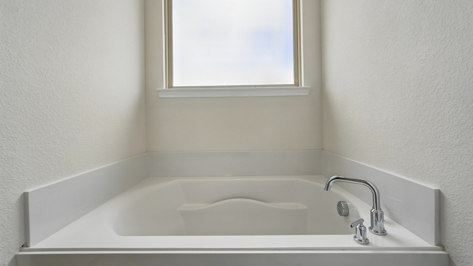 primary bathroom with large vanity and brown cabinets