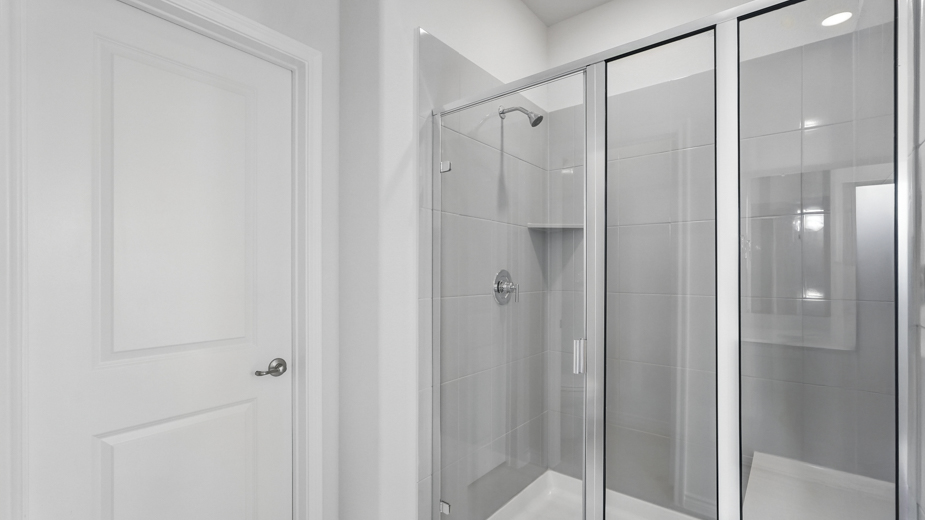 primary bathroom with large vanity and brown cabinets