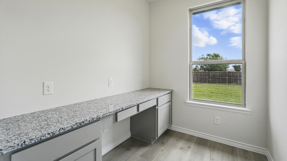primary bathroom with large vanity and brown cabinets