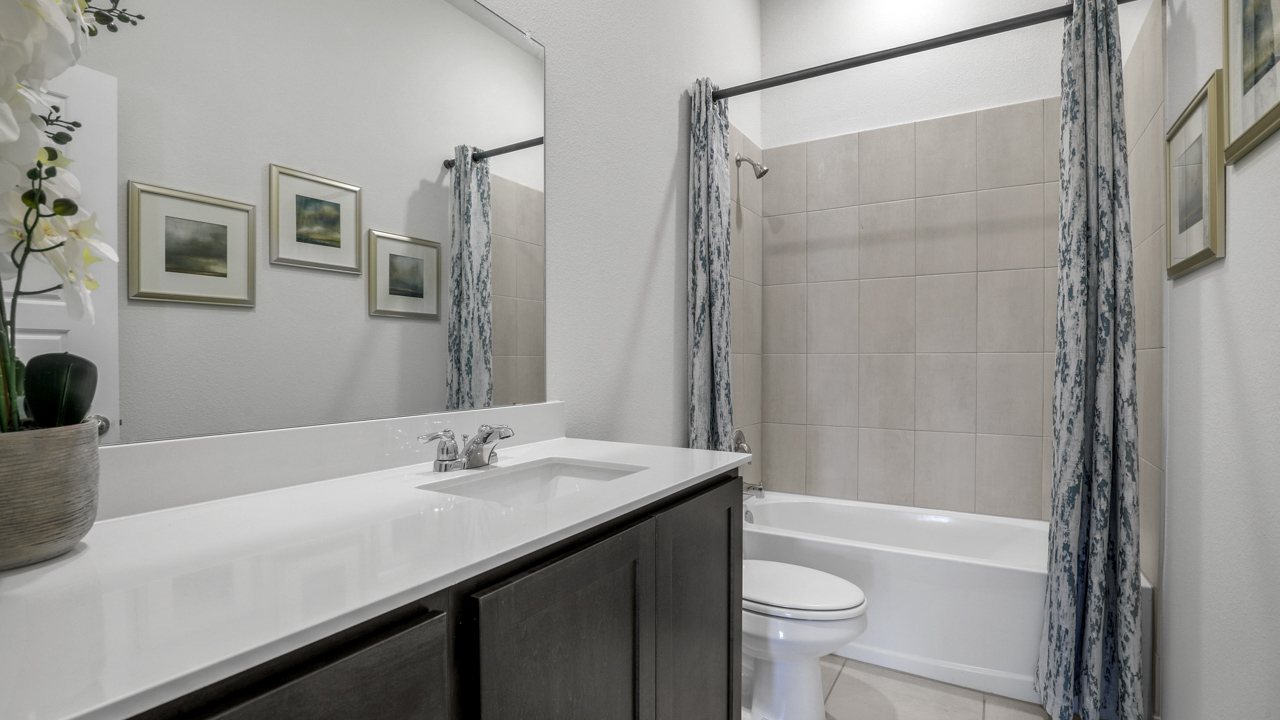 secondary bathroom with large vanity and garden tub