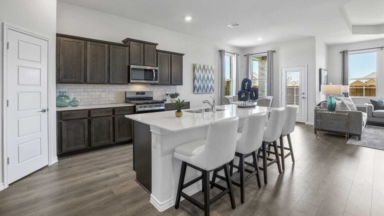 kitchen with large island with brown cabinets and granite countertops