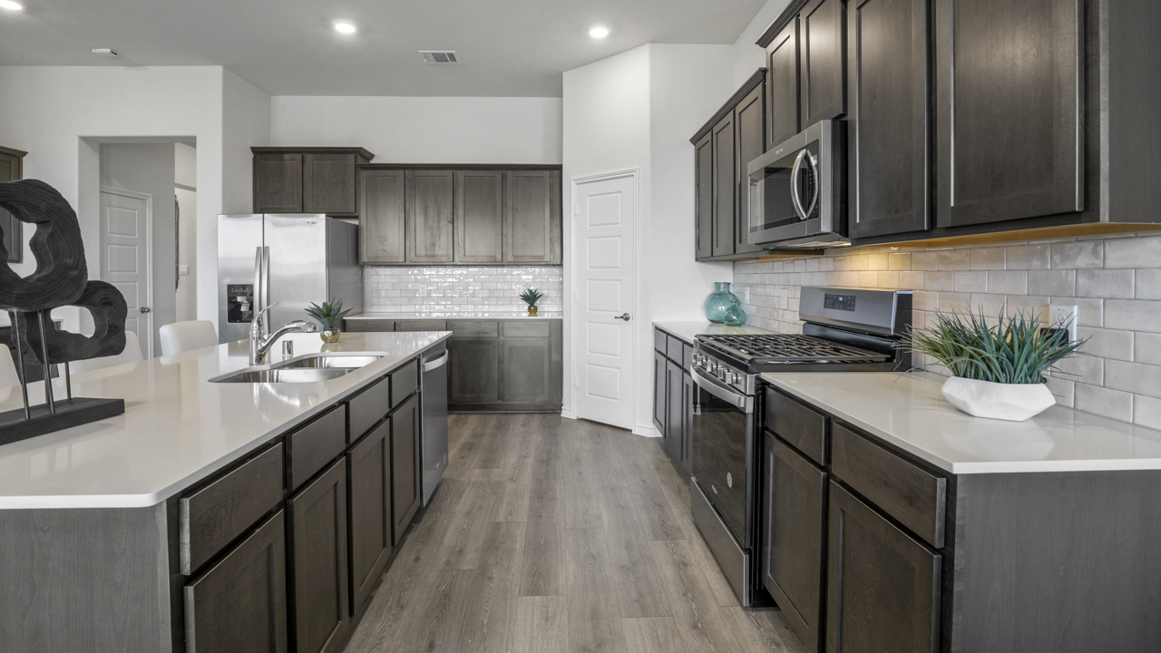 kitchen with large island with brown cabinets and granite countertops