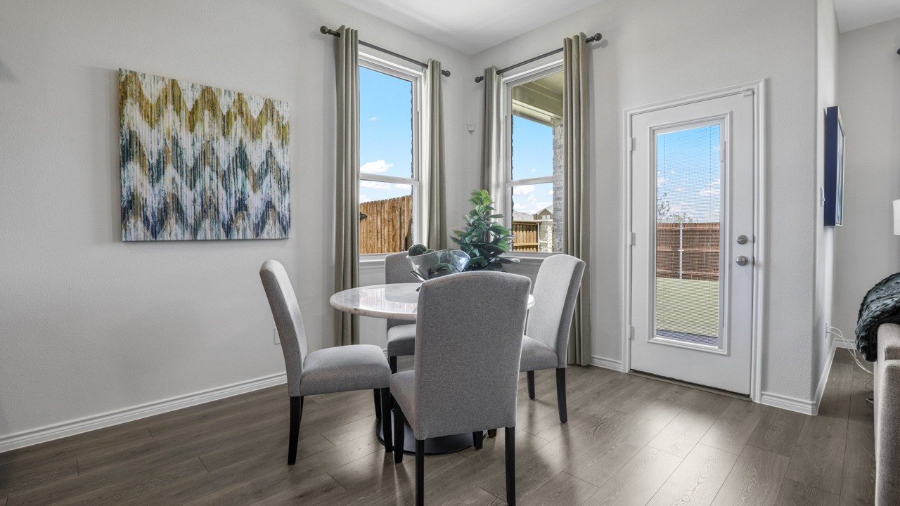 breakfast nook with table and windows next to back door