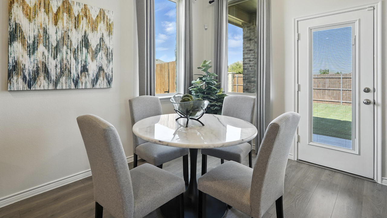 breakfast nook with table and windows next to back door