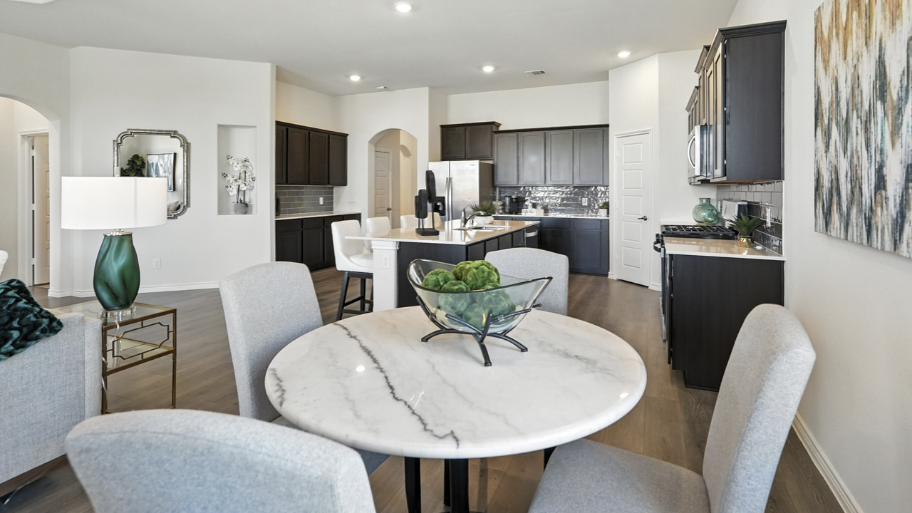 breakfast nook with table and windows next to back door