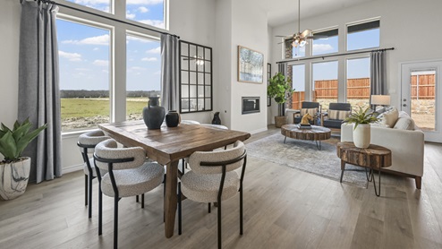 large living area with tall ceiling and several windows