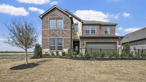large two story model home with brick and stone