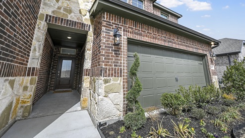 two story model front porch entry with brick and stone accents