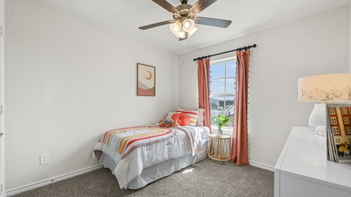 secondary bedroom with small twin bed and ceiling fan