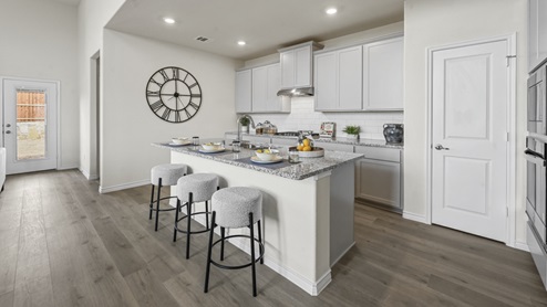 large kitchen with island and white cabinets
