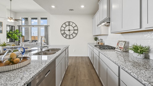 elongated kitchen counters with white cabinets