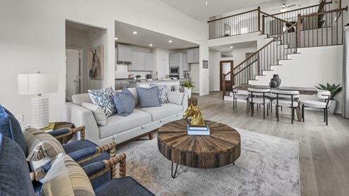 large living area with views into up stairs and kitchen