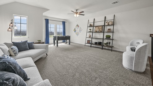 oversized upstairs loft with windows and carpet