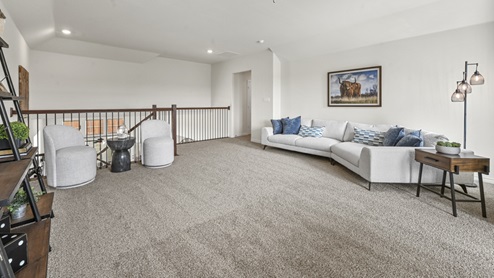 oversized upstairs loft with railing overlooking living room
