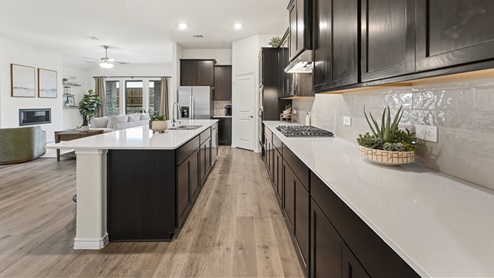 large kitchen with elongated countertops and stainless steel appliances