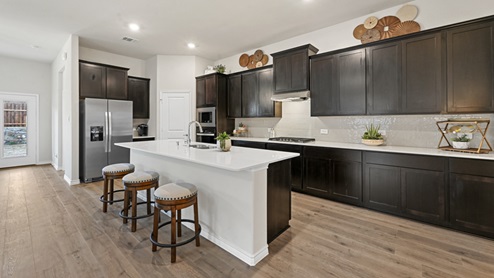 large kitchen with elongated countertops and stainless steel appliances