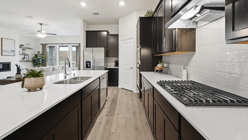 large kitchen with elongated countertops and stainless steel appliances