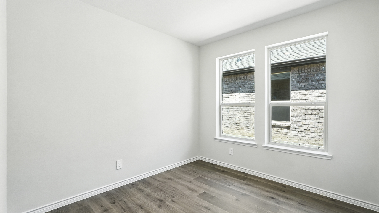 dining area with hardwood floors and large windows facing the backyard providing natural light