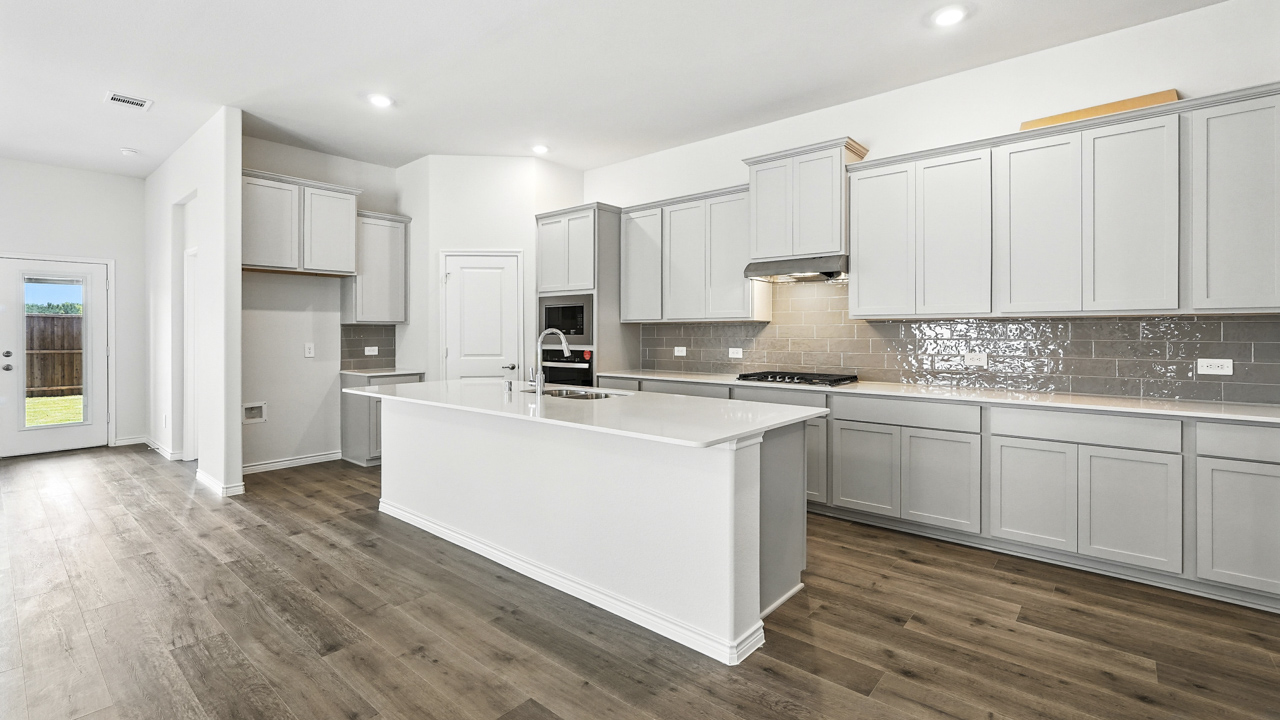 kitchen area with white cabinets and light colored counters and island with hardwood floors