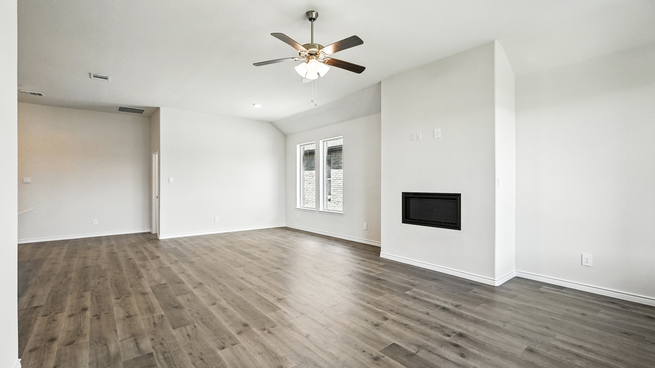 open concept living area with hardwood floors fire place