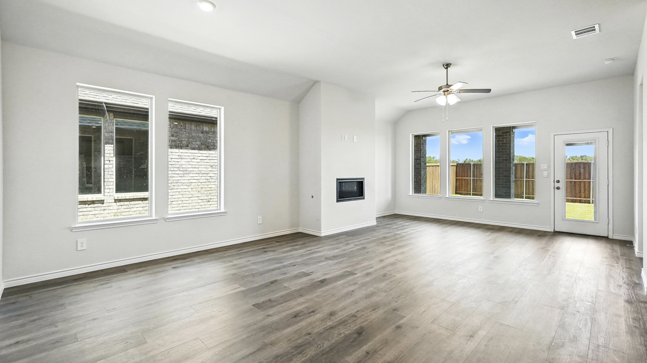 open concept living area with hardwood floors fire place