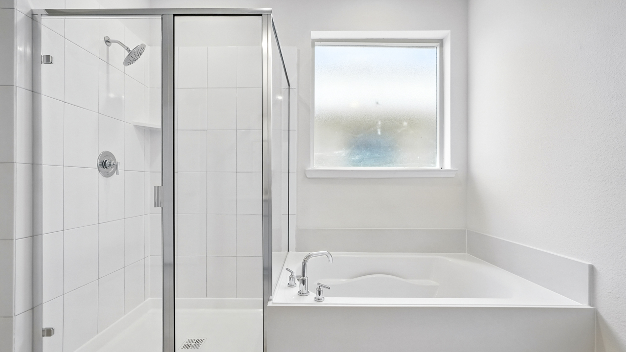 primary bathroom with double vanity sinks.