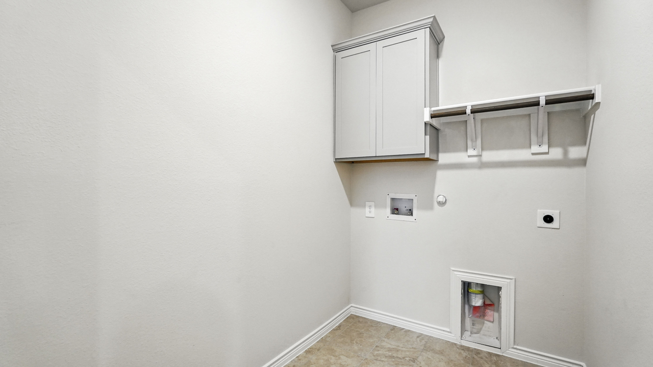 Laundry room with built in storage cabinets.