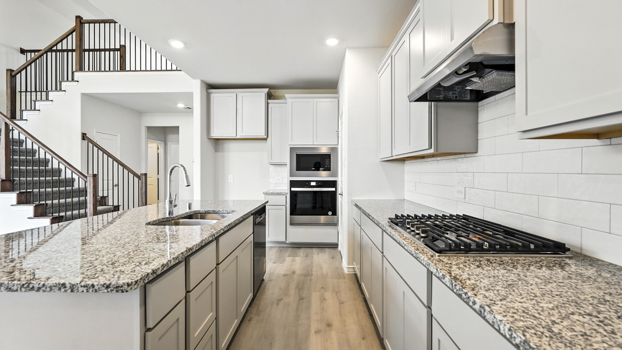 Kitchen island overlooking living room with windows