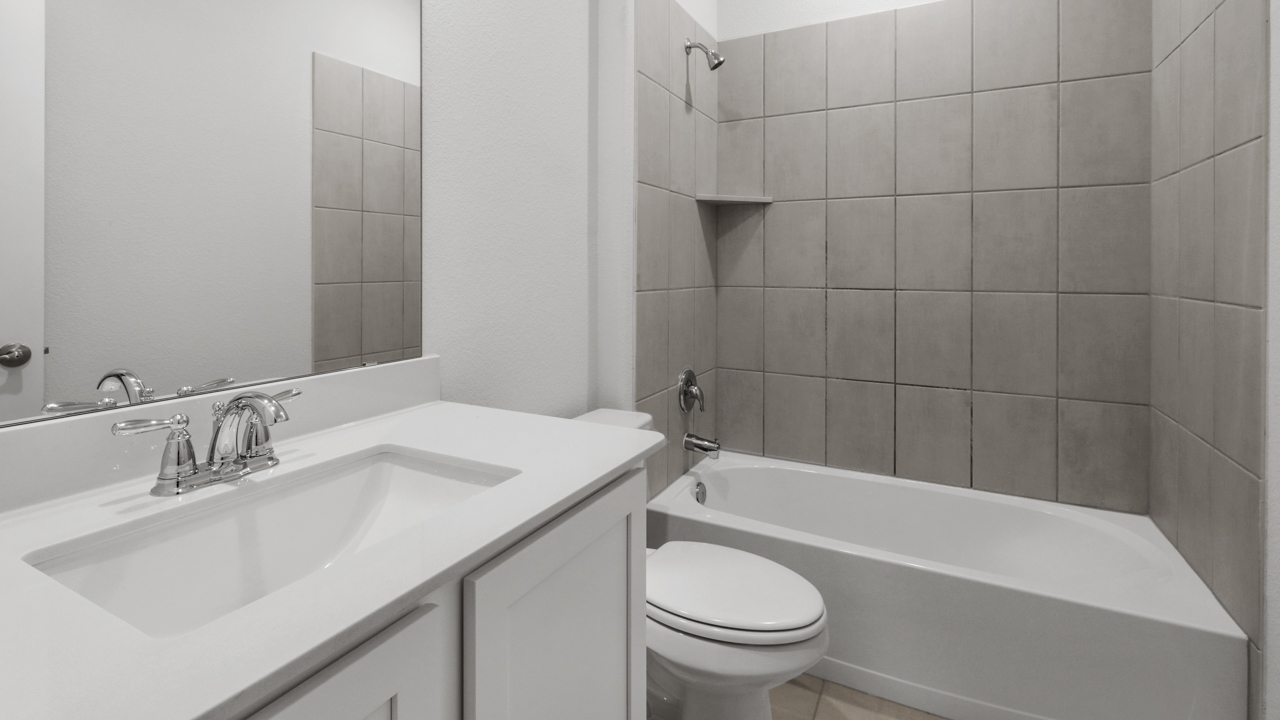secondary bathroom with vanity and garden tub