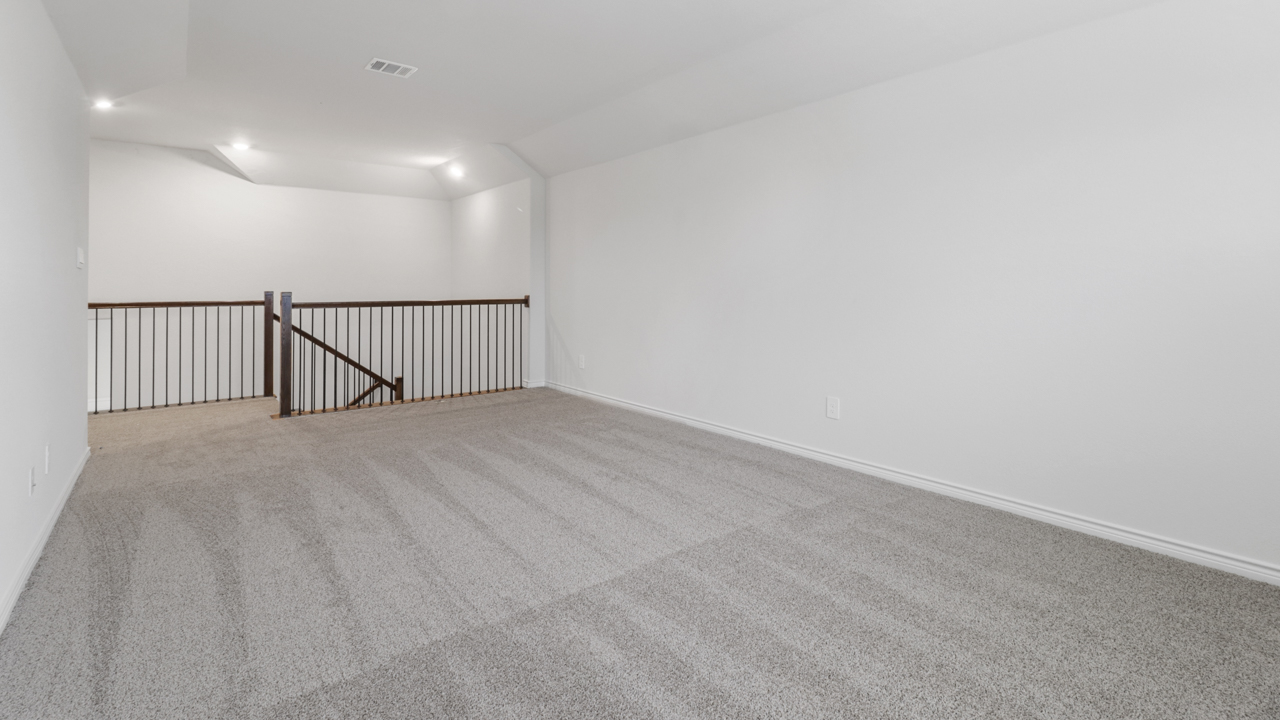 Kitchen island overlooking living room with windows next to stairs