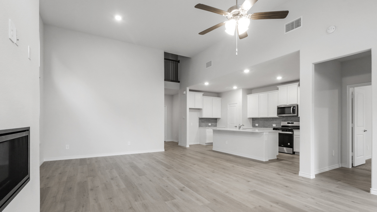Living room overlooking kitchen with ceiling fan