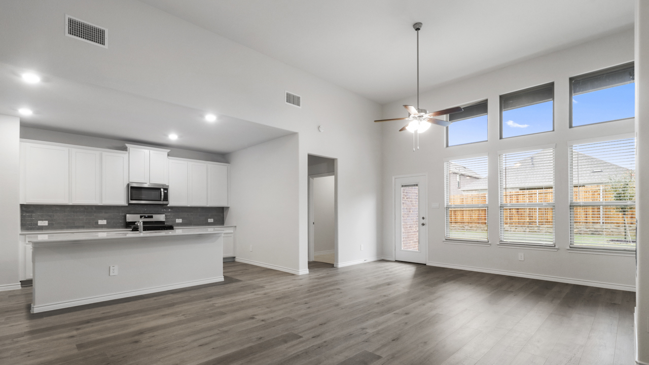 Large living room and windows next to kitchen