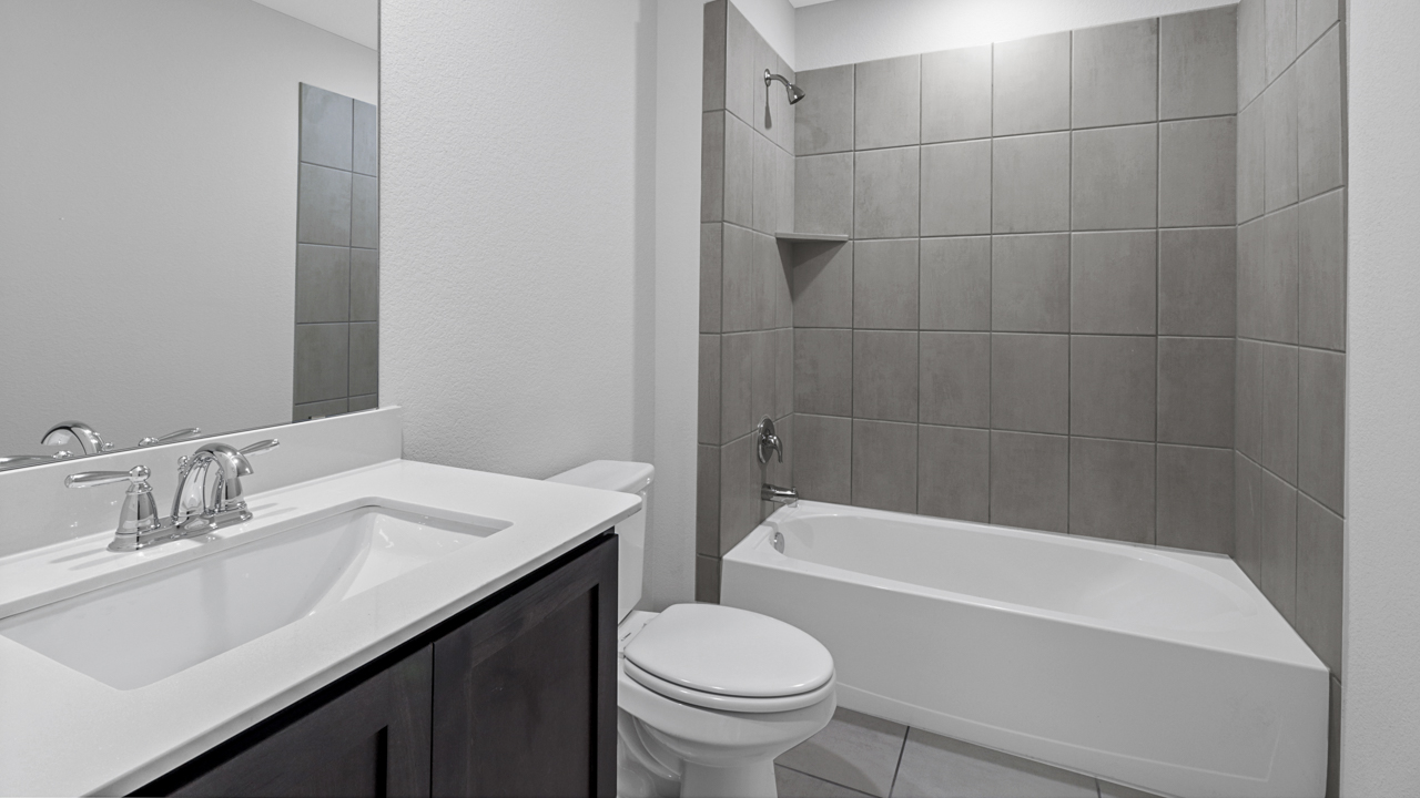 bathroom with sink toilet and shower bath tub combined