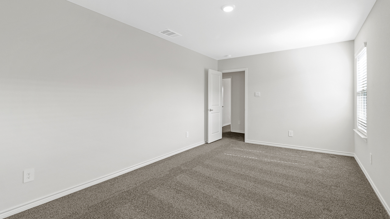 open bedroom with carpet