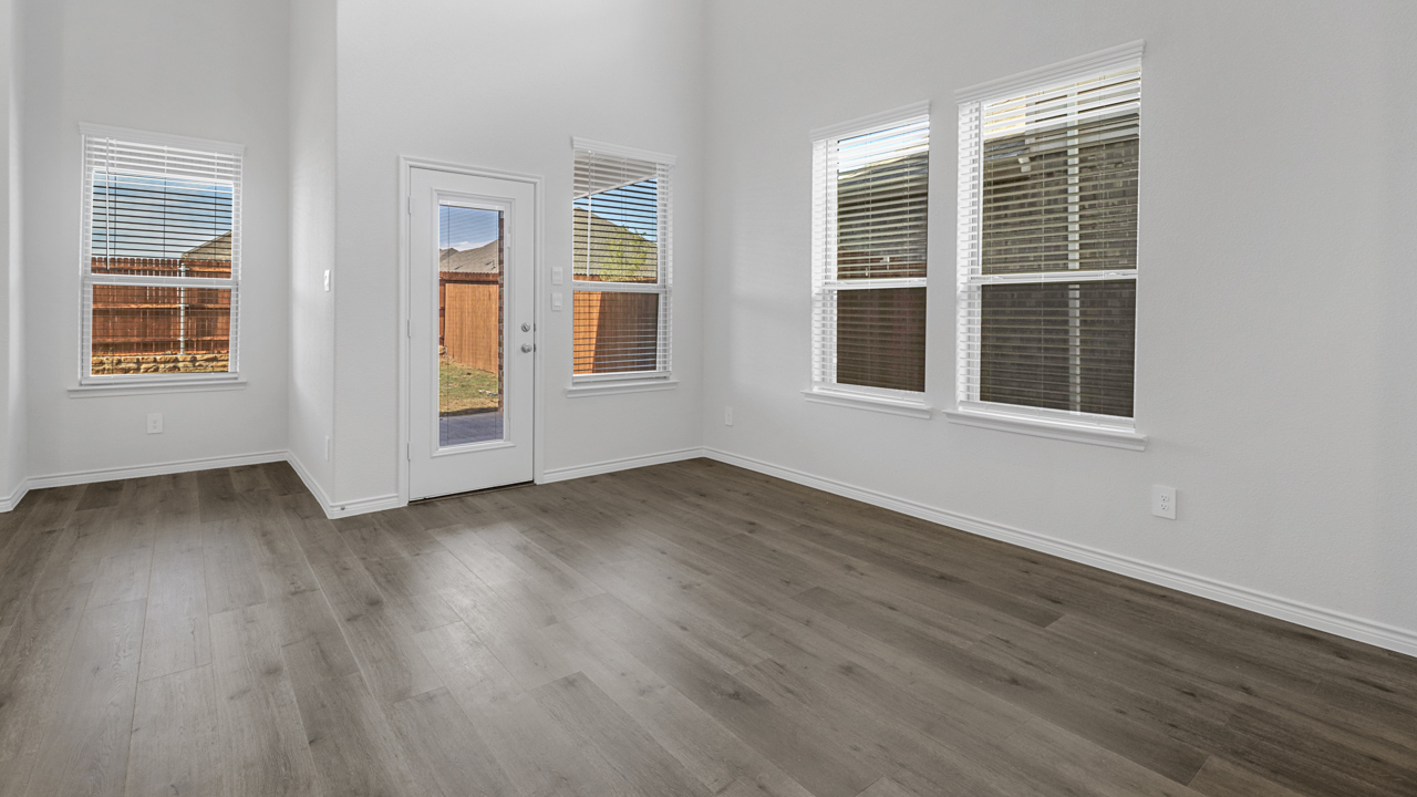 a view of the living space with a door and windows facing the backyard