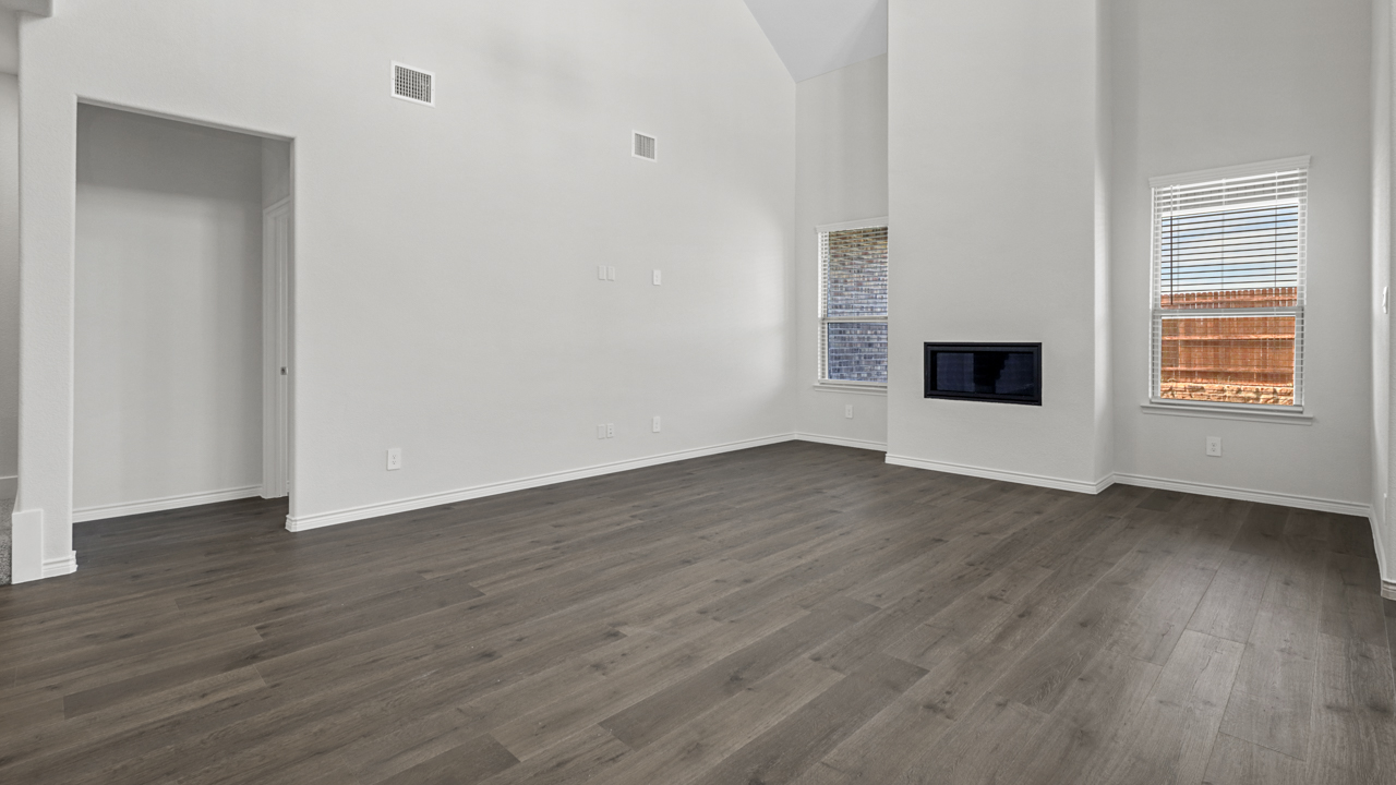 a built in fireplace in the middle of two windows