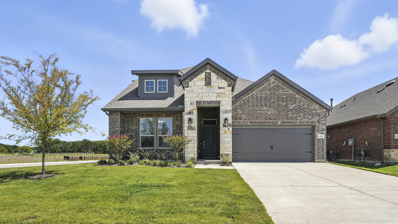 Front exterior of home with brick siding.