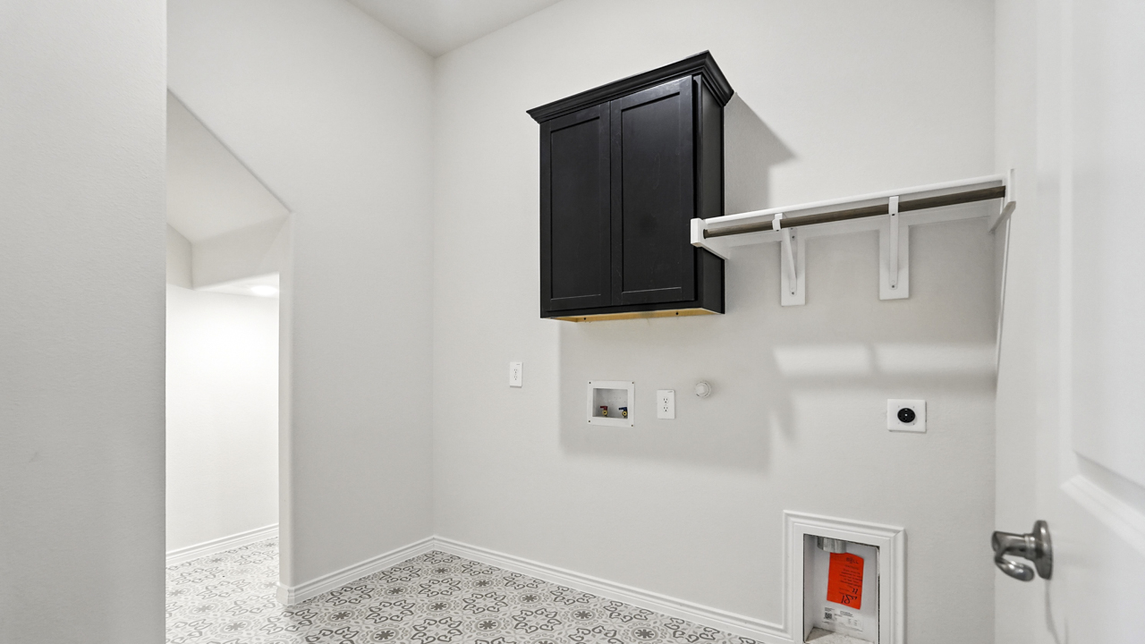 Laundry room with built in storage cabinet.