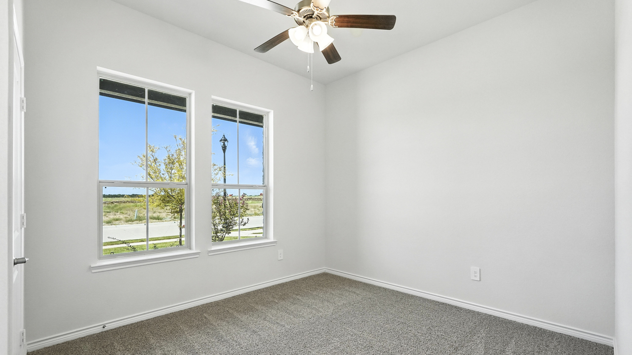 Bedroom with windows for natural lighting.