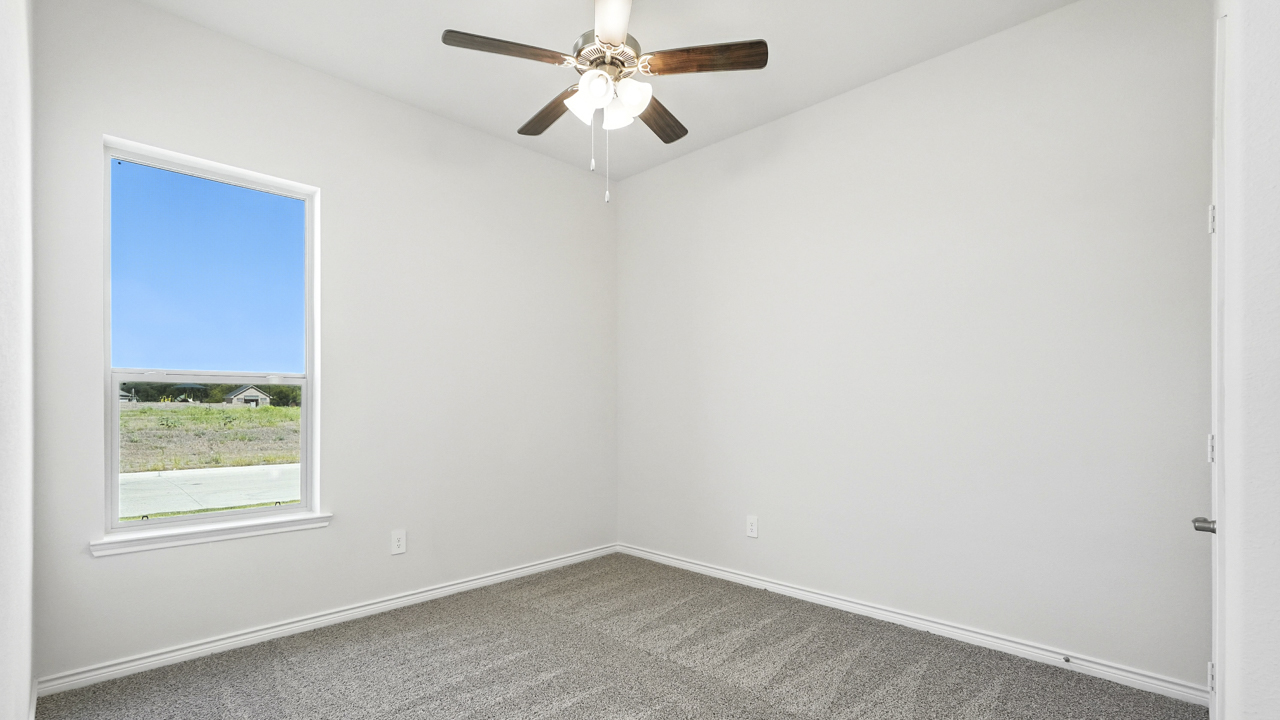 Bedroom with windows for natural lighting.
