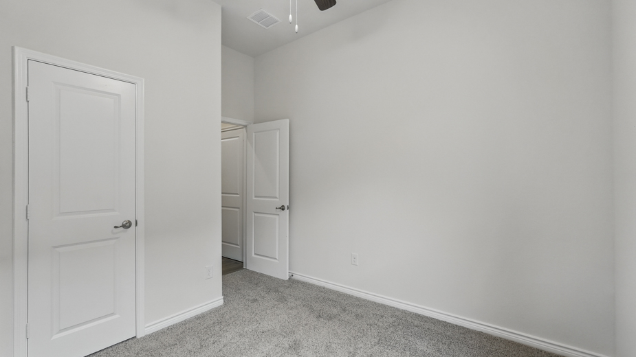 Bedroom with a closet and carpeted floors.