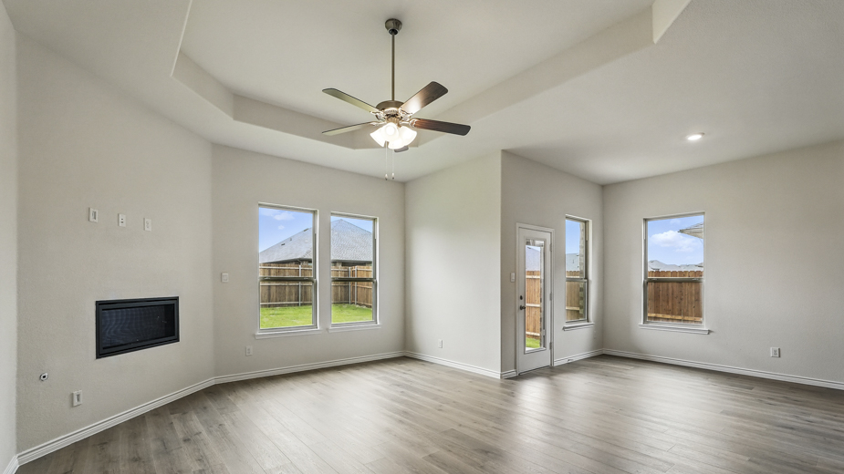 Living room with several windows for natural lighting.