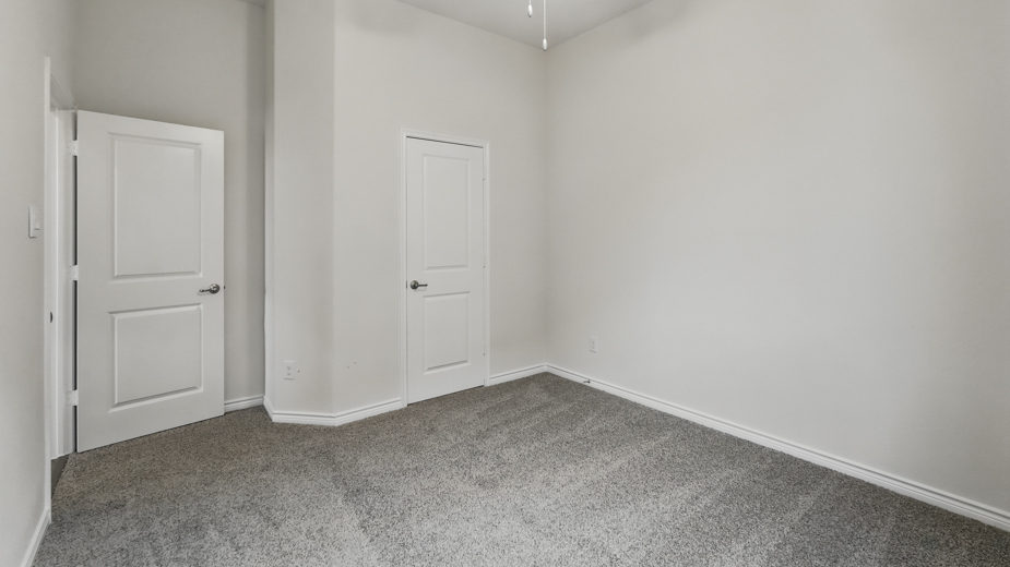 Bedroom with carpeted floors and a closet.