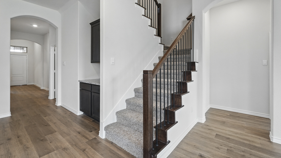 Front entryway with carpeted stairs.